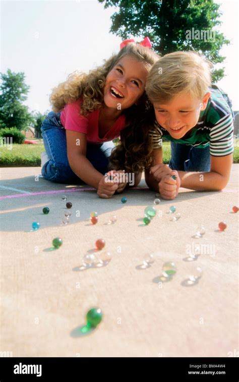 Kids Playing Marbles Stock Photo Alamy