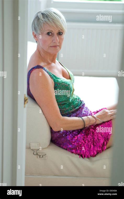 Mature Woman Sits In Short Evening Dress Stock Photo Alamy