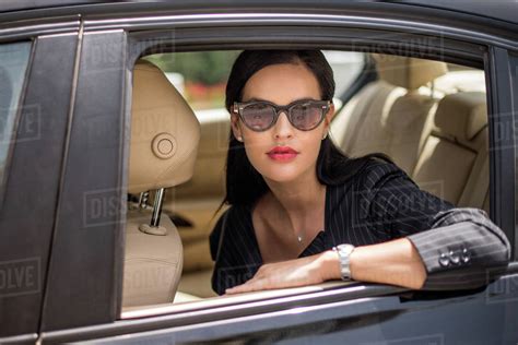 Portrait Of Stylish Businesswoman At Backseat Car Window Dubai United