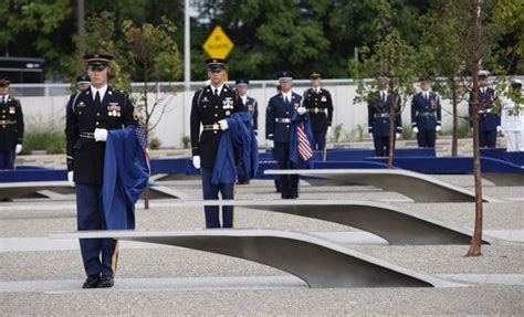 Soldiers Hold Ceremonial Cloths That Were Draped Over The 184 Memorial