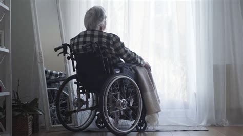 Back View Of Old Caucasian Man Sitting In Wheelchair In Front Of Big