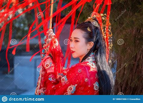 unidentified chinese woman in chinese traditional dress at the temple of confucius in beijing