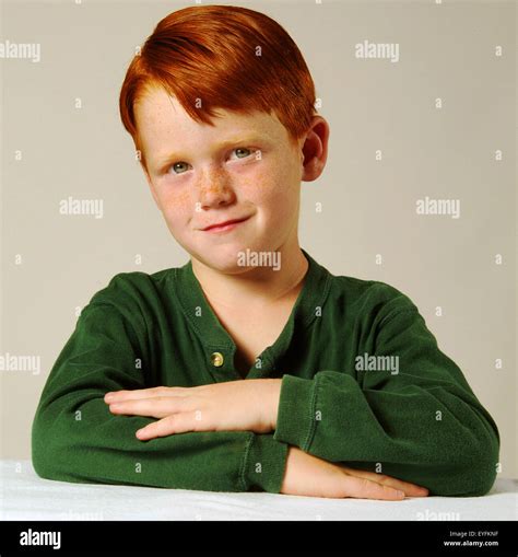 A Self Confident Red Headed Five Year Old Boy Poses In A Studio In