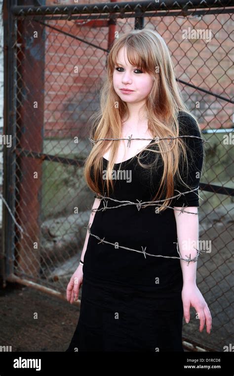 Teenage Blonde Girl Tied With Fake Barbed Wire During A Band Photo Shoot February 2008 Stock