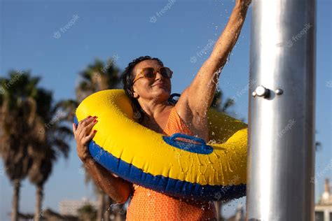 Free Photo Portrait Of Woman Taking A Shower On The Beach