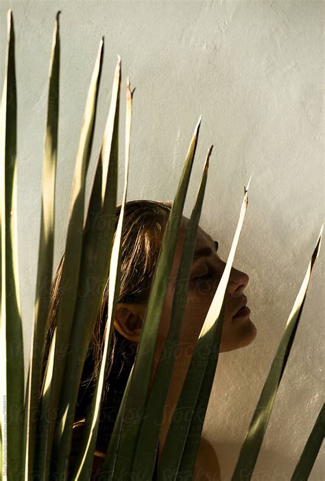 Portrait Of A Beautiful Girl With Palm Leaf By Stocksy Contributor