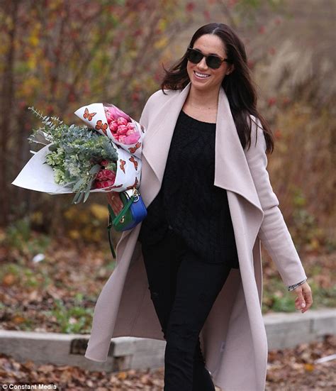 Meghan Markle Struggles To Hide Her Smile While Carrying A Fresh