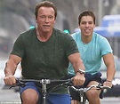 Arnold Schwarzenegger cycles with look-alike lovechild Joseph Baena ...