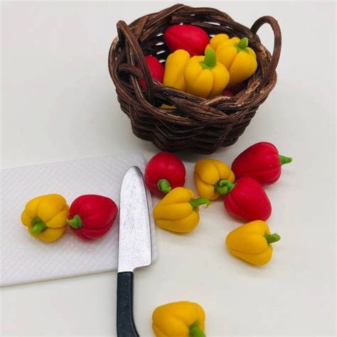 Small Yellow And Red Peppers Next To A Knife On A Cutting Board Near A