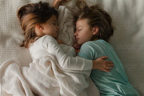 Sisters Cuddling In Bed By Stocksy Contributor Amanda Worrall Stocksy
