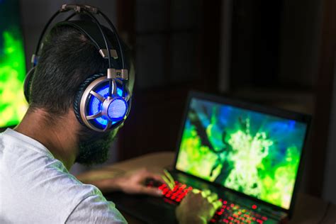 Young Gamer Playing Video Game Wearing Headphone Stock Photo Download