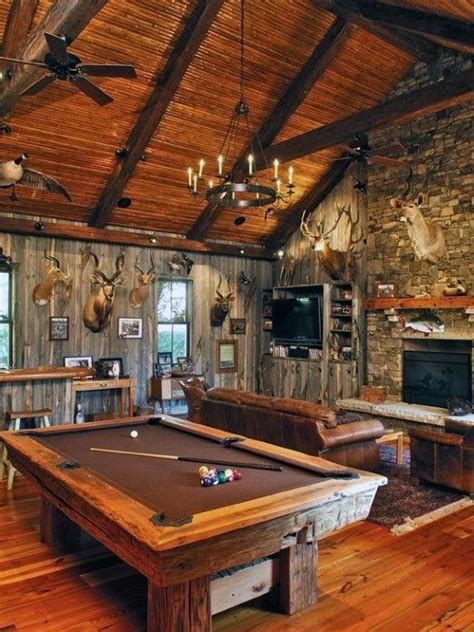 A Pool Table In The Middle Of A Living Room With Wood Floors And