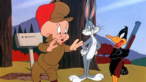 Elmer Fudd Bald Cartoon Character Standing With Bugs Bunny While Daffy