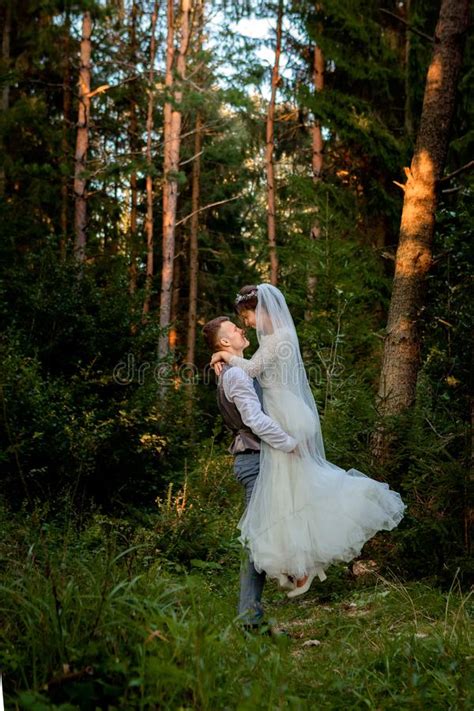 Beautiful Newlyweds Couple Walking In The Forest Honeymooners Stock