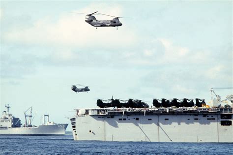 Two Ch 46 Sea Knight Helicopters Fly Above The Amphibious Cargo Ship