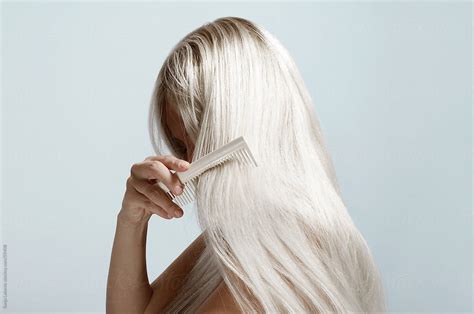 Woman Combing Long Blond Hair By Stocksy Contributor Sonja Lekovic