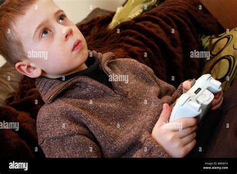 Young Boy Playing Holding Remote Controls For Xbox 360 Stock Photo Alamy