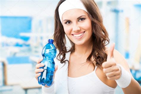 Woman With Bottle Of Water At Fitness Club Stock Photo By ©gstudio