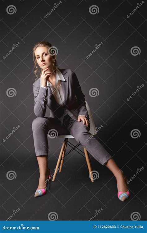 Business Lady In Suit Sits On A Chair On Black Background Stock Image Image Of Beautiful