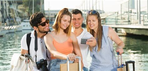 Four Happy Travellers Making Selfie With Mobile Phone Stock Image