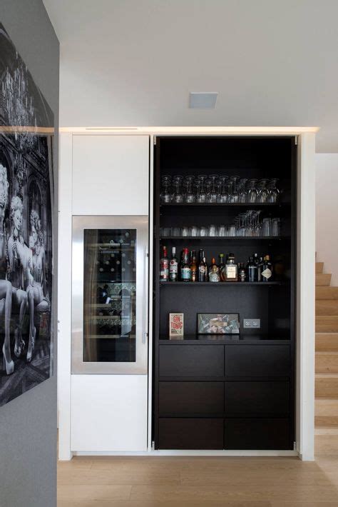 Custom Bar Design With Built In Mini Refrigerator And Mirrored Backing