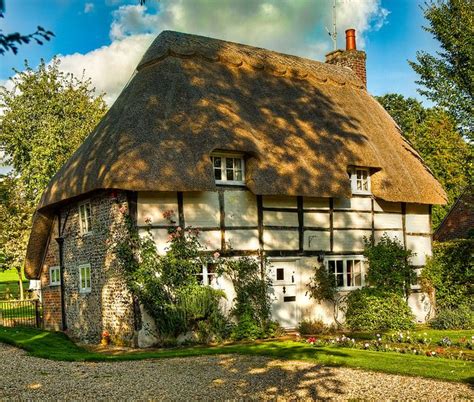 Dappled Sunlight On A Pretty Thatched Cottage At Stoke In Hampshire