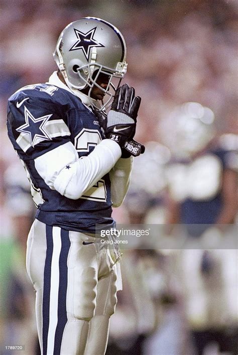 Cornerback Deion Sanders of the Dallas Cowboys prays while standing