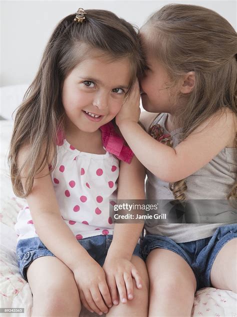 Two Girls Whispering To Each Other High Res Stock Photo Getty Images
