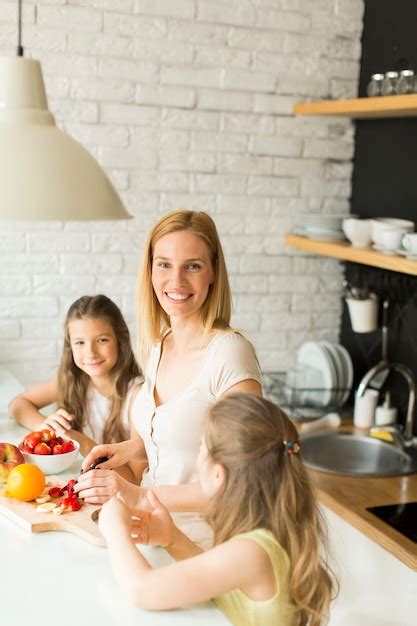 Premium Photo Woman And Two Girls In The Kitchen