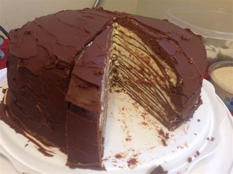 Chocolate Crepe Cake With Layers Of Hazelnut Buttercream And Vanilla Meringue Topped With