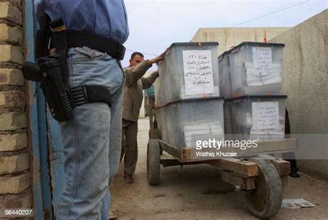 An Iraqi Policeman Stands Guard As Iraqis Load Ballot Boxes Onto News Photo Getty Images