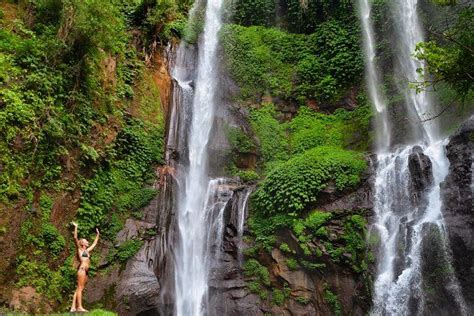 Woman Stand Under Cave Waterfall Featuring Bali Travel And Indonesia