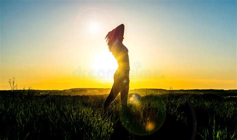 Silhouette Young Woman In Front Of A Beautiful Sunset