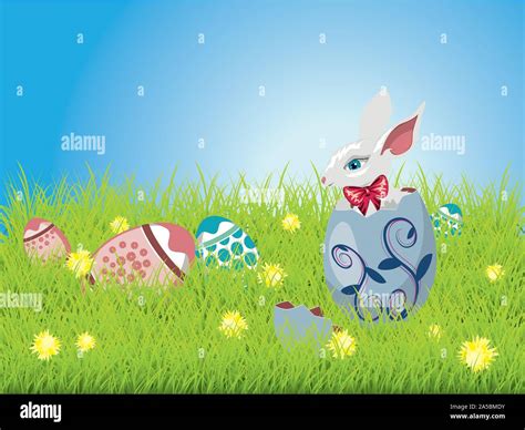 Cute Easter Bunny Sitting Inside A Colorful Cracked Egg On Grass Field