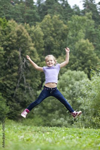 Happy Little Girl Jumping In Summer Day Buy This Stock Photo And