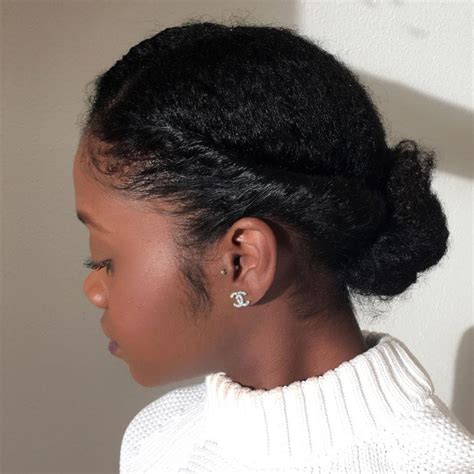 A natural protective hairstyle like this one encourages hair to grow and looks pretty feminine at the same time. Simple Protective Updo | Natural hair updo, Natural hair ...