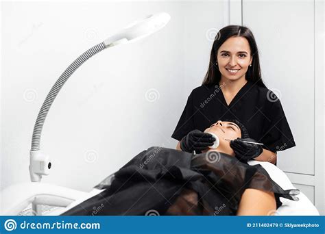 Cosmetologist Make Procedure For Cleaning Skin With Steel Tool From