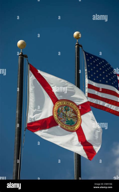 Florida State Flag United States Flag Flying On Flagpoles On Blue Sky