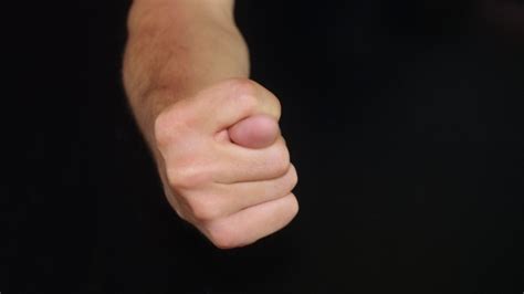 Mans Hand Showing Fig Sign Isolated On Black Stock Footage Videohive