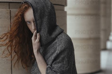 Caucasian Woman Hiding Face Behind Hood Photo12 Tetra Images Ivan Ozerov