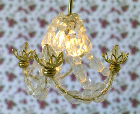 They are often finished with beautiful crystal prisms and shapes to refract light. Petite Pursuits: DIY Crystal Chandelier