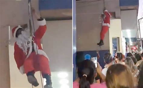 Vídeo Papai Noel desce prédio de rapel enrosca a barba nos fios e