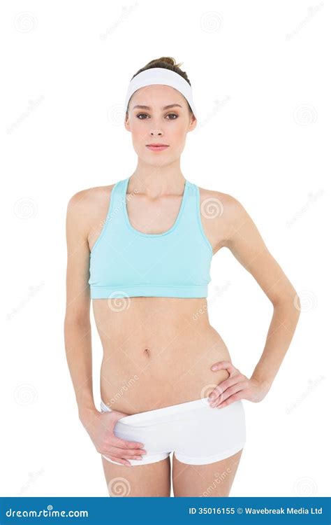 Serious Sporty Woman Posing With Hand On Hips Looking At Camera Stock