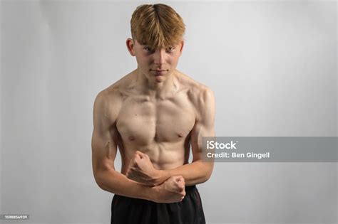 Teenage Boy Flexing His Muscles Stock Photo Download Image Now 14