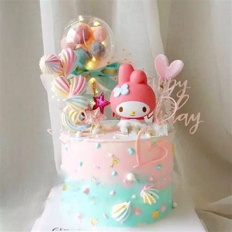 A Hello Kitty Birthday Cake With Balloons And Candy