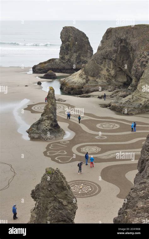 People Walking A Circles In The Sand Labyrinth At Face Rock Beach In