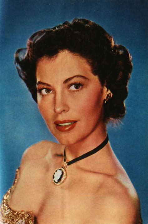 An Old Photo Of A Woman Wearing A Dress And Necklace With Her Hair In A Bun