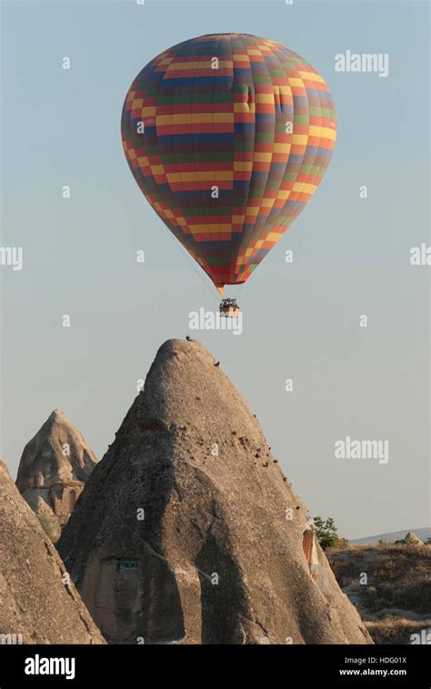 Hot Air Balloon Floats Above Fairy Chimneys In Cappadocia Turkey Stock