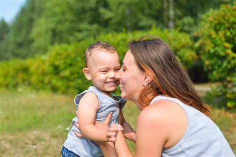 Happy Family Having Fun Outdoors Mother And Baby Rubbing Noses Positive Emotions Stock Image