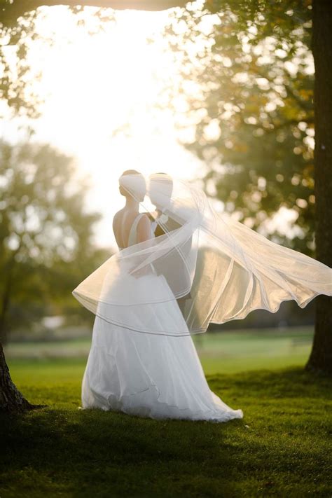Couples Portrait With Windswept Veil Wedding Inside Wedding Dresses